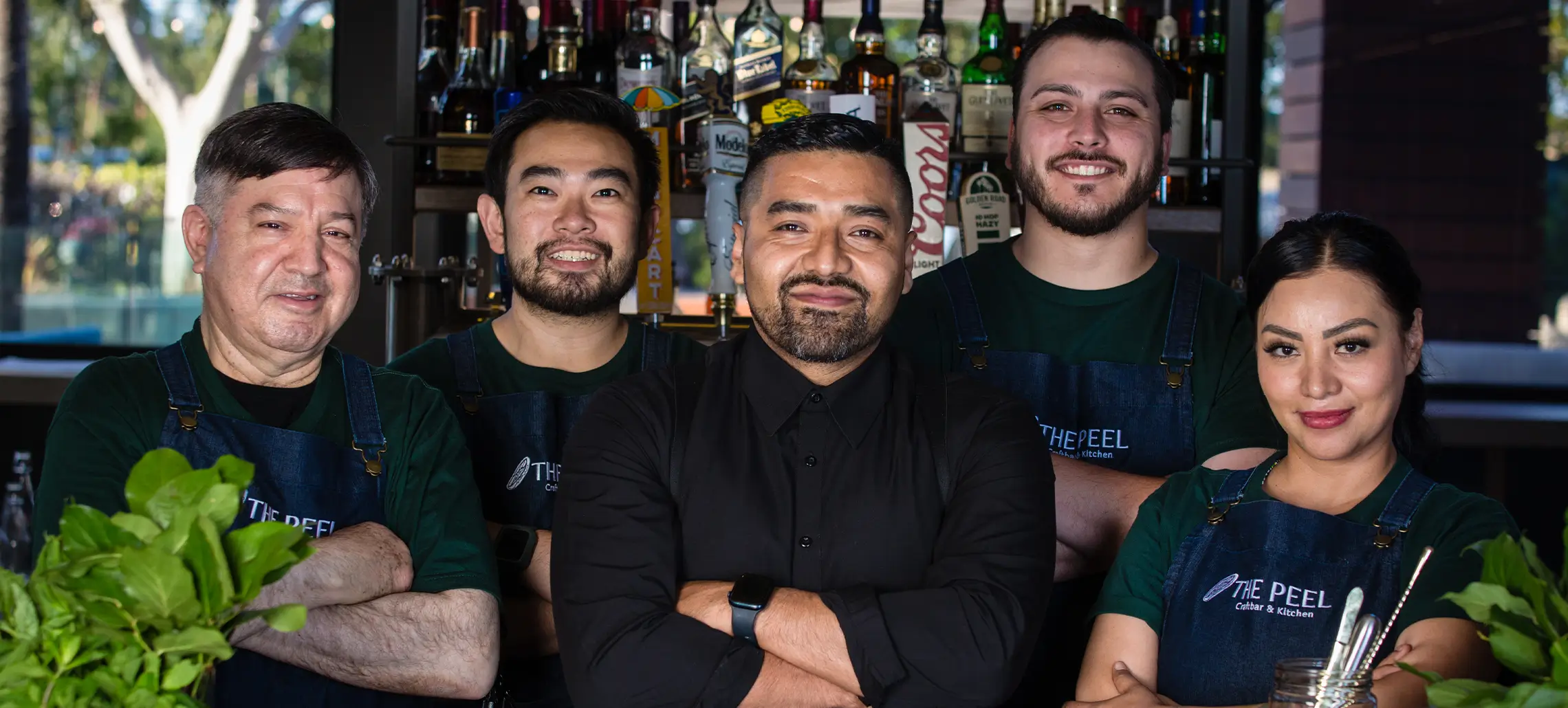 group of servers and bartenders pose together at the peel
