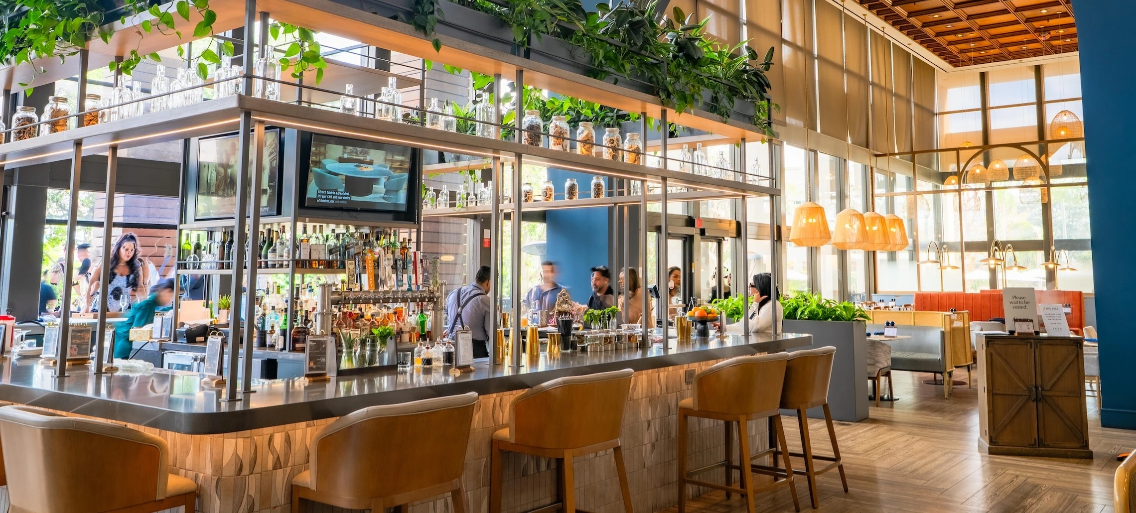 A bar tender serving customers at the Peel in Anaheim, CA