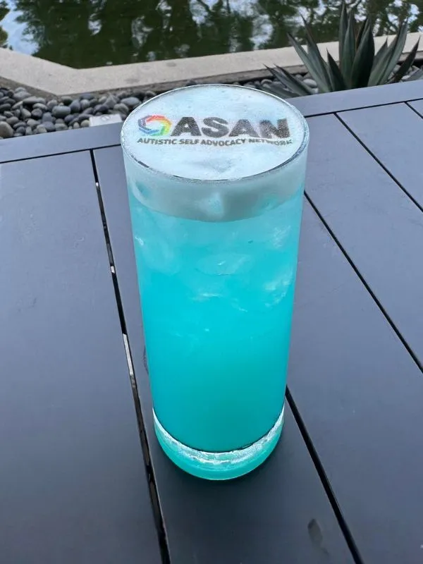 a blue cocktail with ASAN art