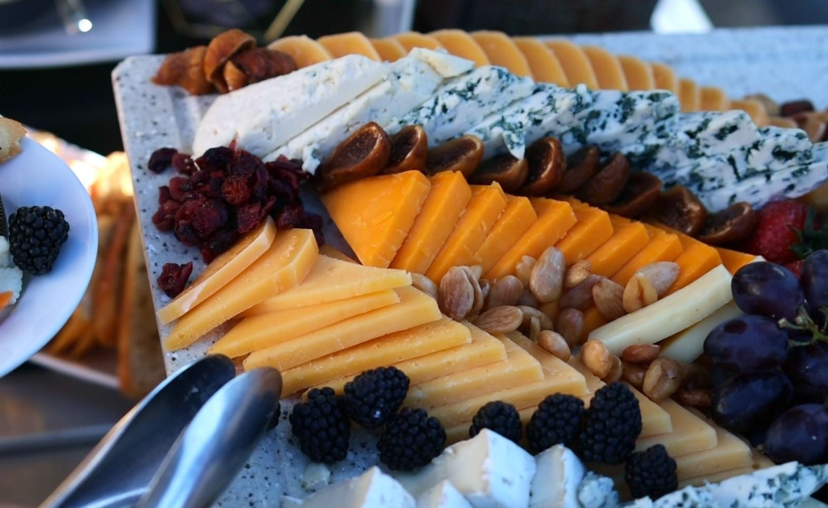 a guest selecting fruit from a platter