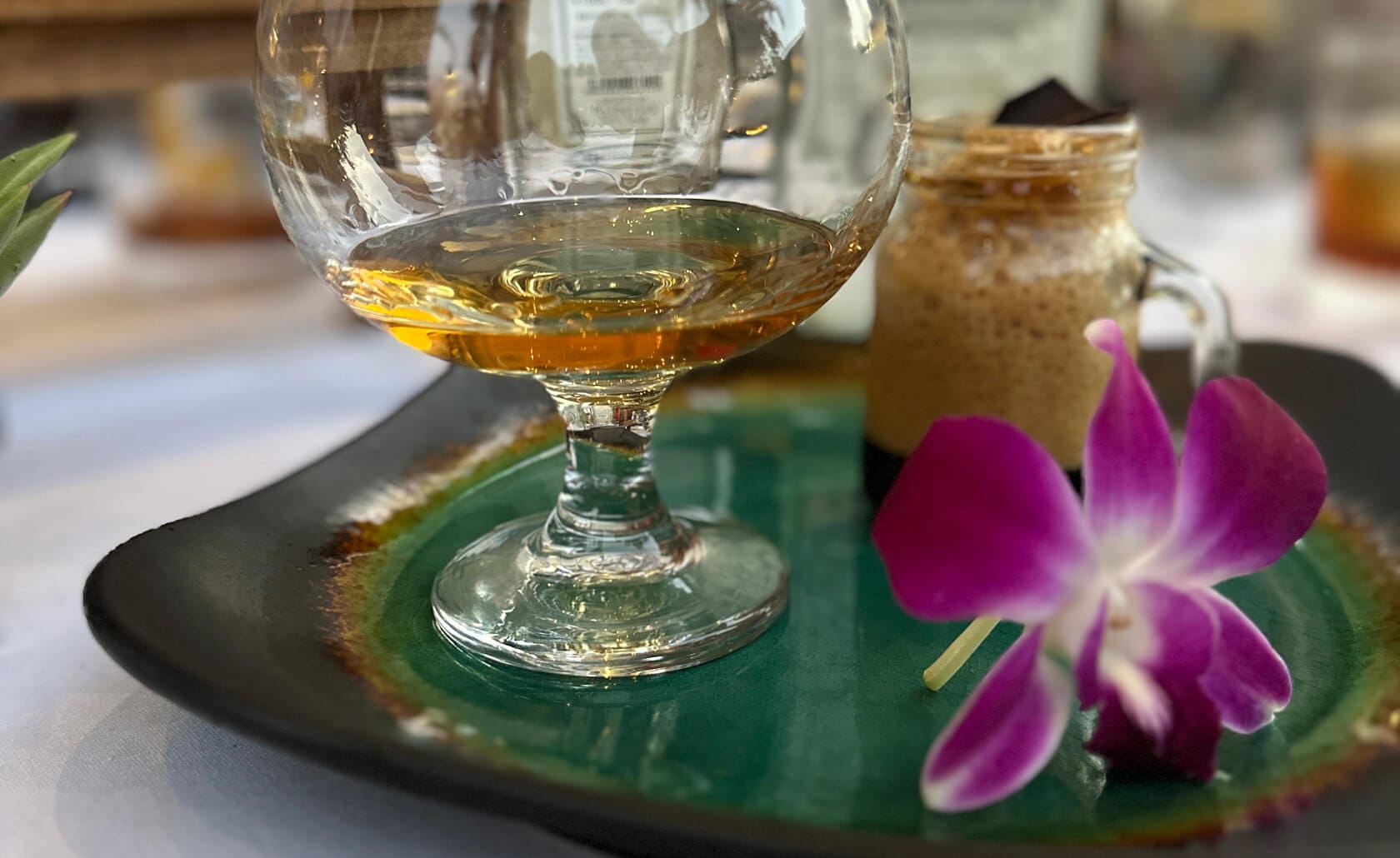 A close view of a cocktail and a flower