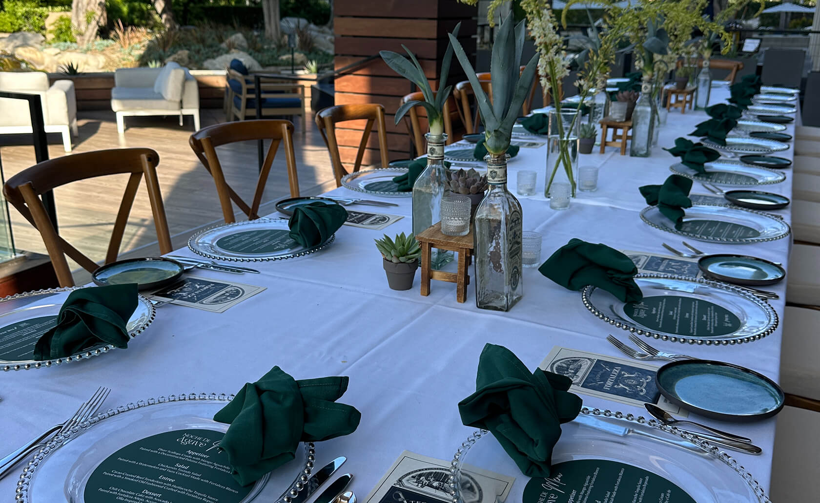 A dining table on the patio with a white table cloth