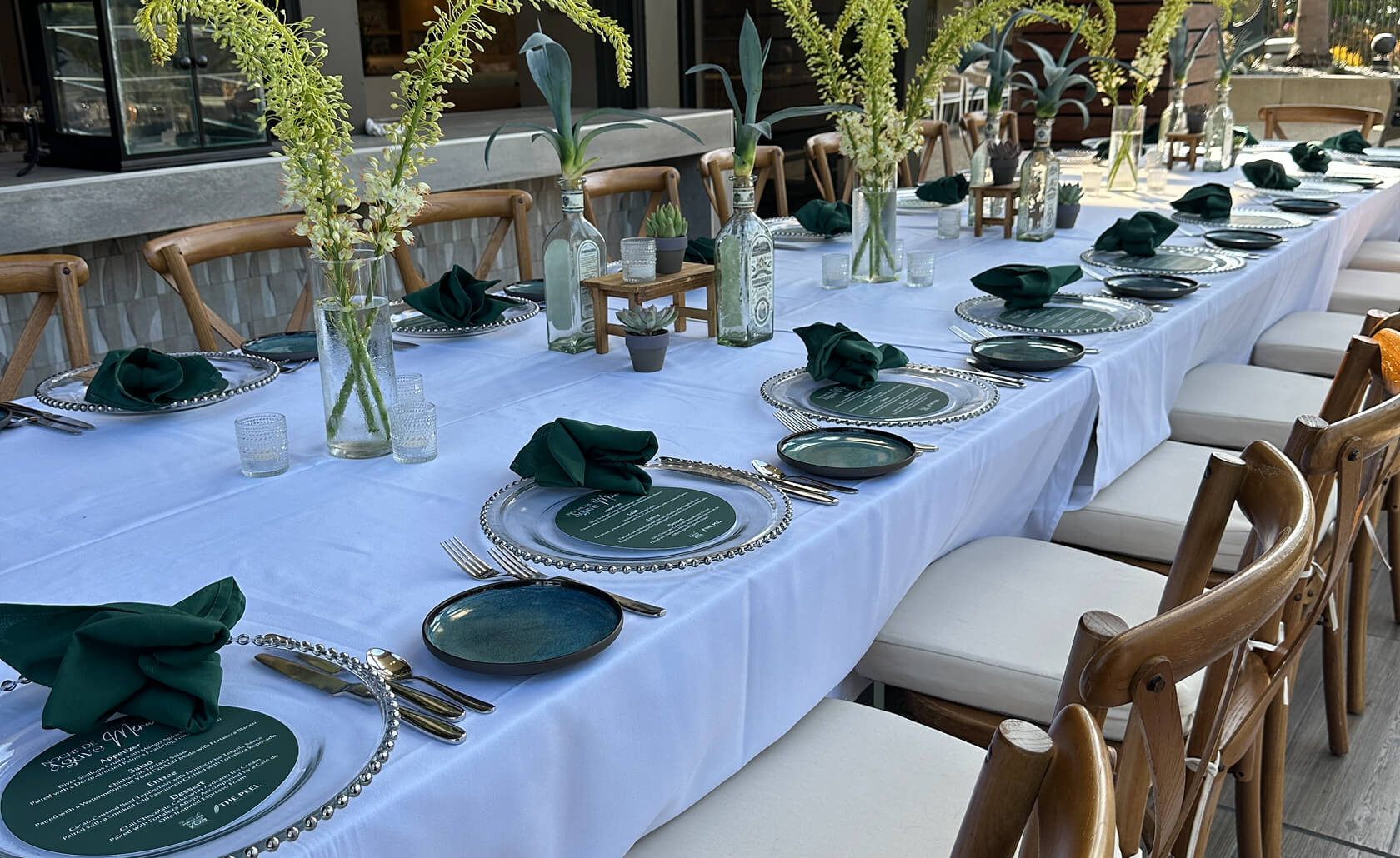 An outdoor dining table on the patio decorated for an event