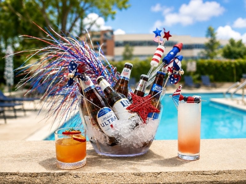 two cocktails next to a glass bowl with patriotic decorations